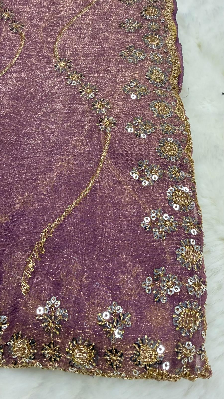 Close-up of gold sequin and thread embroidery border