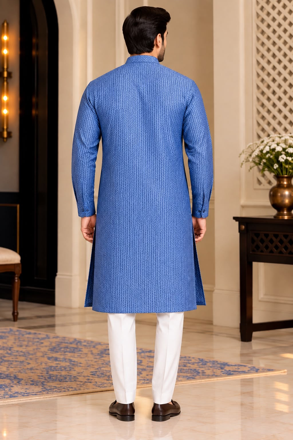 Front view of blue textured men's kurta styled with white trousers