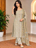 Model wearing a beige embroidered tunic and trousers with a matching patterned scarf